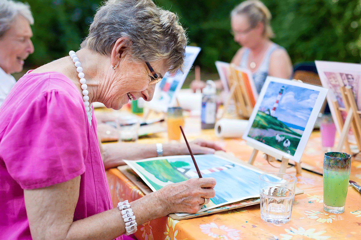 woman spends time painting in memory care activities