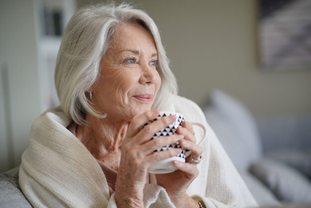 Entering Your New Chapter With Independent Living a woman enjoys a cup of tea in her new independent senior living apartment