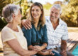 Adult woman sitting with senior parents