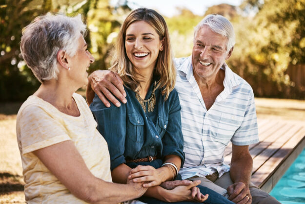 Adult woman sitting with senior parents